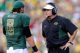 PASADENA, CA - JANUARY 01:  Head coach Chip Kelly of the Oregon Ducks talks with quarterback Jeremiah Masoli #8 during the game against the Ohio State Buckeyes at the 96th Rose Bowl game on January 1, 2010 in Pasadena, California.  (Photo by Kevork Djansezian/Getty Images)