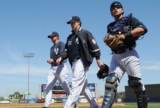 TAMPA, FL - MARCH 5: Pitcher Phil Hughes #65 (middle) of the New York Yankees walks to the dugout before play against the Tampa Bay Rays March 5, 2010 at the George M. Steinbrenner  Field in Tampa, Florida. (Photo by Al Messerschmidt/Getty Images) 