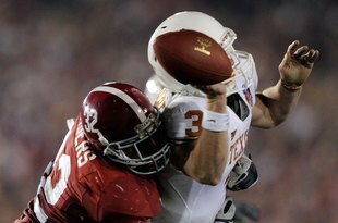 PASADENA, CA - JANUARY 07:  Quarterback Garrett Gilbert #3 of the Texas Longhorns fumbles the ball as he is hit by linebacker Eryk Anders #32 of the Alabama Crimson Tide during the Citi BCS National Championship game at the Rose Bowl on January 7, 2010 in Pasadena, California.  (Photo by Kevork Djansezian/Getty Images)