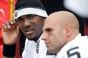 KANSAS CITY, MO - SEPTEMBER 20:  Quarterback JaMarcus Russell #2 of the Oakland Raiders talks with Bruce Gradkowski #5 on the bench during the game against the Kansas City Chiefs at Arrowhead Stadium on September 20, 2009 in Kansas City, Missouri.  (Photo by Jamie Squire/Getty Images)