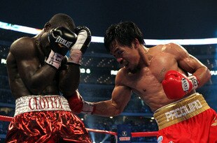ARLINGTON, TX - MARCH 13:  (R-L) Manny Pacquiao of the Philippines throws a right to the body of Joshua Clottey of Ghana during the WBO welterweight title fight at Cowboys Stadium on March 13, 2010 in Arlington, Texas. Pacquiao defeated Clottey by unanimous decision.  (Photo by Jed Jacobsohn/Getty Images)
