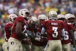 JACKSONVILLE, FL - JANUARY 01:  Quarterback E.J. Manuel #3 of the Florida State Seminoles calls out a play in the huddle against the West Virginia Mountaineers during the Konica Minolta Gator Bowl on January 1, 2010 at Jacksonville Municipal Stadium in Jacksonville, Florida. Florida State defeated West Virginia 33-21 in Bobby Bowden's last game as a head coach for the Seminoles.  (Photo by Doug Benc/Getty Images)