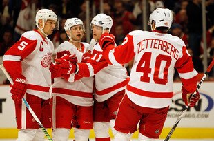 CHICAGO - MARCH 07: (L-R) Nicklas Lidstrom #5, Brian Rafalski #28, Dan Cleary #11 and Henrik Zetterberg #40 of the Detroit Red Wings celebrate a second period goal against the Chicago Blackhawks at the United Center on March 7, 2010 in Chicago, Illinois. (Photo by Jonathan Daniel/Getty Images)