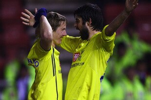 WIGAN, ENGLAND - FEBRUARY 21:  Roman Pavlyuchenko of Tottenham celebrates his goal with Vedran Corluka during the Barclays Premier League match between Wigan Athletic and Tottenham Hotspur at the DW Stadium on February 21, 2010 in Wigan, England.  (Photo by Matthew Lewis/Getty Images)