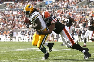 CLEVELAND, OH - OCTOBER 25:  Quinn Johnson #45 of the Green Bay Packers makes a catch as he is hit by David Bowens #96of the Cleveland Browns at Cleveland Browns Stadium on October 25, 2009 in Cleveland, Ohio.  (Photo by Matt Sullivan/Getty Images)