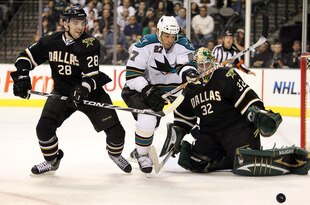 DALLAS - MARCH 16:  Goaltender Kari Lehtonen #32 of the Dallas Stars makes a save in front of Manny Malhotra #27 of the San Jose Sharks and Mark Fistric #28 at American Airlines Center on March 16, 2010 in Dallas, Texas.  (Photo by Ronald Martinez/Getty Images)