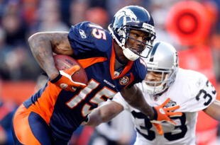 DENVER - DECEMBER 20:  Brandon Marshall #15 of the Denver Broncos stiff arms Tyvon Branch #33 of the Oakland Raiders in the second half at Invesco Field at Mile High on December 20, 2009 in Denver, Colorado. The Raiders defeated the Broncos 20-19.  (Photo by Jeff Gross/Getty Images)