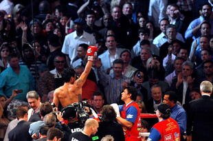 ARLINGTON, TX - MARCH 13:  Manny Pacquiao of the Philippines celebrates in the ring after defeating Joshua Clottey of Ghana during the WBO welterweight title fight at Cowboys Stadium on March 13, 2010 in Arlington, Texas. Pacquiao defeated Clottey by unanimous decision.  (Photo by Tom Pennington/Getty Images)
