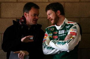FONTANA, CA - FEBRUARY 20:  Dale Earnhardt Jr., driver of the #88 AMP Energy Juice/National Guard Chevrolet, speaks with Crew Chief Lance McGrew in the garage area during practice for the NASCAR Sprint Cup Series Auto Club 500 at Auto Club Speedway on February 20, 2010 in Fontana, California.  (Photo by Jason Smith/Getty Images for NASCAR)