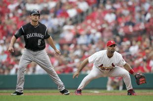 ST. LOUIS - MAY 10:  Albert Pujols #5 of the St. Louis Cardinals overs Matt Holliday #5 of the Colorado Rockies as he leads off base on May 10,2006 at Busch Stadium in St. Louis, Missouri. The St. Louis Cardinals defeated the Colorado Rockies 7-4. (Photo by Elsa/Getty Images)
