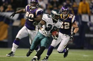 MINNEAPOLIS - JANUARY 04:   Brian Westbrook #36 of the Philadelphia Eagles carries the ball for a 71 yard touchdown as Fred Evans #90 and Chad Greenway #52 of the Minnesota Vikings defend during the NFC Wild Card playoff game on January 4, 2009 at the Hubert H. Humphrey Metrodome in Minneapolis, Minnesota. The Eagles defeated the Vikings 26-14.(Photo by Elsa/Getty Images)