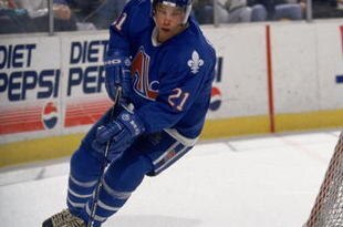 BUFFALO, NY - APRIL 9:  Peter Forsberg #21 of the Quebec Nordiques controls the puck behind the net during the NHL game against the Buffalo Sabres at the Aud in Buffalo, New York on April 9, 1995.  (Photo by Rick Stewart /Getty Images/NHLI)