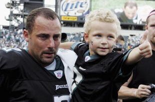 PHILADELPHIA, PA -SEPTEMBER 25:  Luke Akers, held by his father kicker David Akers #2 of the Philadelphia Eagles, gives a thumbs up after his father kicked the game winning field goal against the Oakland Raiders during their game on September 25, 2005 at Lincoln Financial Field in Philadelphia, Pennsylvannia.The Eagles defeated the Raiders 23-20.(Photo by Jim McIsaac/Getty Images)                                           