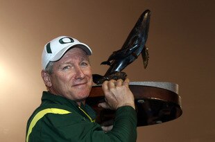 SAN DIEGO, CA - DECEMBER 30:   Head Coach Mike Bellotti of the University of Oregon Ducks holds the winner's trophy after beating the Oklahoma State University Cowboys in the Pacific Life Holiday Bowl at Qualcomm Stadium on December 30, 2008 in San Diego, California. The Ducks won 42-31. (Photo by Donald Miralle/Getty Images)