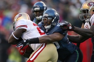 SEATTLE - DECEMBER 6:  Darryl Tapp #55 of the Seattle Seahawks wraps up Frank Gore #21 of the San Francisco 49ers during their NFL game on December 6, 2009 at Qwest Field in Seattle, Washington. The Seahawks defeated the 49ers 20-17. (Photo by Otto Greule Jr./Getty Images)