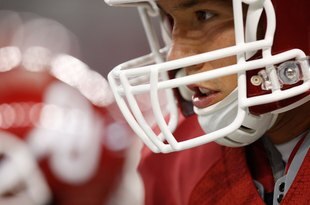 ARLINGTON, TX - SEPTEMBER 05:  Quarterback Sam Bradford #14 of the Oklahoma Sooners warms up before a game against the Brigham Young Cougars at Cowboys Stadium on September 5, 2009 in Arlington, Texas.  (Photo by Ronald Martinez/Getty Images)
