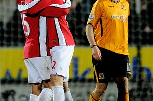 HULL, ENGLAND - MARCH 13: Nicklas Bendtner of Arsenal celebrates victory with Denilson in front of Kevin Kilbane of Hull Cityl during the Barclays Premier League match between Hull City and Arsenal at KC Stadium on March 13, 2010 in Hull, England.  (Photo by Laurence Griffiths/Getty Images)
