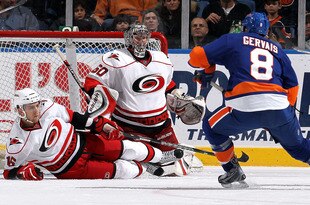 UNIONDALE, NY - FEBRUARY 06:  Justin Peters #60 and Brandon Sutter #16 of the Carolina Hurricanes defends the net against Bruno Gervais #8 of the New York Islanders on February 6, 2010 at Nassau Coliseum in Uniondale, New York.  (Photo by Jim McIsaac/Getty Images)
