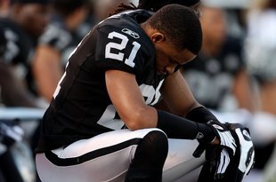 OAKLAND, CA - JANUARY 03:  Nnamdi Asomugha #21 of the Oakland Raiders sits on the bench against the Baltimore Ravens during an NFL game at Oakland-Alameda County Coliseum on January 3, 2010 in Oakland, California.  (Photo by Jed Jacobsohn/Getty Images)