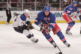NEW YORK - MARCH 18: Vinny Prospal #20 of the New York Rangers skates with the puck in front of TJ Oshie #74 of the St. Louis Blues at Madison Square Garden on March 18, 2010 in New York City.  (Photo by Nick Laham/Getty Images)