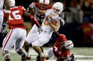 ARLINGTON, TX - DECEMBER 5:  Jordan Shipley #8 of the Texas Longhorns is stopped by Phillip Dillard #52 and Larry Asante #4 of the Nebraska Cornhuskers for a 15-yard penalty in the final minutes of the game at Cowboys Stadium on December 5, 2009 in Arlington, Texas.  Texas won the game 10-6.  (Photo by Jamie Squire/Getty Images)