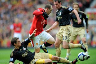 MANCHESTER, ENGLAND - MARCH 21: Wayne Rooney (C) of Manchester United is challenged by Daniel Agger (L) and Jamie Carragher of Liverpool  during the Barclays Premier League match between Manchester United and Liverpool at Old Trafford on March 21, 2010 in Manchester, England.  (Photo by Michael Regan/Getty Images)