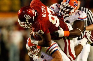 MIAMI - JANUARY 08:  Gerald McCoy #93 of the Oklahoma Sooners is tackled by Tim Tebow #15 and Jason Watkins #77 of the Florida Gators during the first half of the FedEx BCS National Championship game at Dolphin Stadium on January 8, 2009 in Miami, Florida.  (Photo by Marc Serota/Getty Images)