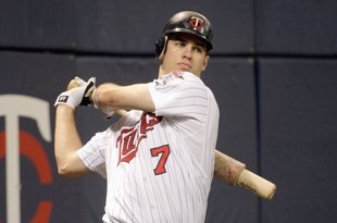 MINNEAPOLIS - OCTOBER 06:  Joe Mauer #7 of the Minnesota Twins warms up ondeck during the American League tiebreaker game against the Detroit Tigers on October 6, 2009 at Hubert H. Humphrey Metrodome in Minneapolis, Minnesota. (Photo by Jamie Squire/Getty Images)