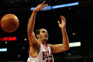CHICAGO - FEBRUARY 26: Joakim Noah #13 of the Chicago Bulls is fouled while shooting by Marcus Camby #21 of the Portland Trail Blazers at the United Center on February 26, 2010 in Chicago, Illinois. The Bulls defeated the Trail Blazers 115-111 in overtime. NOTE TO USER: User expressly acknowledges and agrees that, by downloading and/or using this Photograph, User is consenting to the terms and conditions of the Getty Images License Agreement. (Photo by Jonathan Daniel/Getty Images)