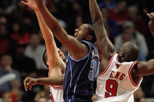 CHICAGO - MARCH 09: C.J. Miles #34 of the Utah Jazz puts up a shot between Brad Miller #52 and Loul Deng #9 of the Chicago Bulls at the United Center on March 9, 2010 in Chicago, Illinois. The Jazz defeated the Bulls 132-108. NOTE TO USER: User expressly acknowledges and agrees that, by downloading and/or using this Photograph, User is consenting to the terms and conditions of the Getty Images License Agreement. (Photo by Jonathan Daniel/Getty Images)