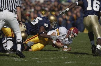 SOUTH BEND, IN-OCTOBER 20:  USC Trojan quarterback Carson Palmer #3 is brought down by Ryan Roberts #95 of the Notre Dame University Fighting Irish during the game on October 20,2001 at Notre Dame Stadium in South Bend, Indiana. Notre Dame defeated USC 16