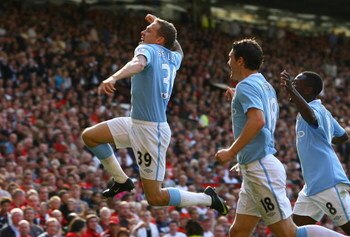 MANCHESTER, ENGLAND - SEPTEMBER 20:  Craig Bellamy of Manchester City celebrates scoring his team's second goal during the Barclays Premier League match between Manchester United and Manchester City at Old Trafford on September 20, 2009 in Manchester, Eng