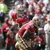 SAN FRANCISCO - SEPTEMBER 20:  Running back Frank Gore #21 of the San Francisco 49ers gets a hand off from quarterback Shaun Hill #13 and runs for a touchdown against the Seattle Seahawks in the first quarter during the home opener at Candlestick Park on 