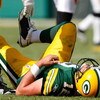 GREEN BAY, WI - SEPTEMBER 20: Quarterback Aaron Rogers #12 of the Green Bay Packers lays on the field after he was sacked in the 4th quarter against the Cincinnati Bengals at Lambeau Field on September 20, 2009 in Green Bay, Wisconsin. The Bengals defeate