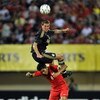 SINGAPORE - JULY 26:  SINGAPORE- JULY 26:  Daniel Agger of Liverpool jumps for the ball over Noh Alam Sham of Singapore during the pre-season friendly soccer match between Singapore and Liverpool at the National Stadium, July 26, 2009 in Singapore.  (Phot