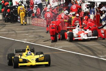 MOTEGI, JAPAN - SEPTEMBER 19: Ryan Briscoe, driver of the #6 Team Penske Dallara Honda pits as Dario Franchitti, drives the #10 Target Chip Ganassi Racing Dallara Honda down pit lane during the IndyCar Series Bridgestone Indy Japan 300 Mile on September 1