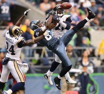 SEATTLE - OCTOBER 21:  Wide receiver Nate Burleson #81 of the Seattle Seahawks leaps for a pass that fell incomplete against Ron Bartell #24 and Oshiomogho Atogwe #21 of the St. Louis Rams at Qwest Field October 21, 2007 in Seattle, Washington. The Seahaw