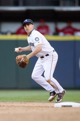 SEATTLE - SEPTEMBER 02:  Jack Wilson #9 of the Seattle Mariners throws to firstbase against the Los Angeles Angels of Anaheim at Safeco Field on September 2, 2009 in Seattle, Washington. (Photo by Otto Greule Jr/Getty Images)