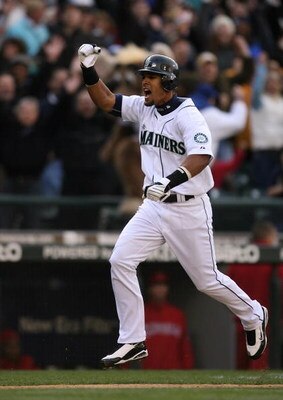 SEATTLE - APRIL 14:  Franklin Gutierrez #21 (R) of the Seattle Mariners celebrates as he scores the winning run in a 3-2 win over the Los Angeles Angels of Anaheim during the Opening Day game on April 14, 2009 at Safeco Field in Seattle, Washington. (Phot