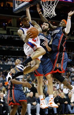 CHARLOTTE, NC - MARCH 28:  Teammates Vladimir Radmanovic #10 and Gerald Wallace #3 of the Charlotte Bobcats try to stop Wilson Chandler #21 of the New York Knicks during their game at Time Warner Cable Arena on March 28, 2009 in Charlotte, North Carolina.