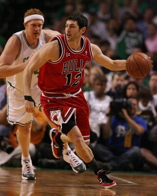 BOSTON - MAY 02:  Kirk Hinrich #12 of the Chicago Bulls heads down court as Brian Scalabrine #44 of the Boston Celtics defends in Game Seven of the Eastern Conference Quarterfinals during the 2009 NBA Playoffs at TD Banknorth Garden on May 2, 2009 in Bost