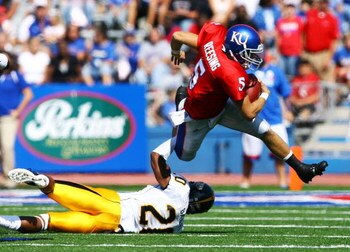 LAWRENCE, KS - SEPTEMBER 26:  Quarterback Todd Reesing #5 of the Kansas Jayhawks evades C.J. Bailey #20 of the Southern Mississippi Golden Eagles during the game on September 26, 2009 at Memorial Stadium in Lawrence, Kansas.  (Photo by Jamie Squire/Getty 