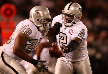 OAKLAND, CA - SEPTEMBER 14: Quarterback JaMarcus Russell #2 of the Oakland Raiders hands the ball off to Michael Bush #29 pf the San Diego Chargers on September 14, 2009 at the Oakland-Alameda County Coliseum in Oakland, California.  (Photo by Ezra Shaw/G
