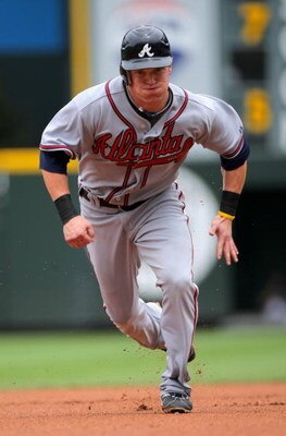 DENVER - JULY 12:  Nate McLouth #13 of the Atlanta Braves runs the base path as he heads for thirdbase on a Martin Prado single in the first inning against the Colorado Rockies during MLB action at Coors Field on July 12, 2009 in Denver, Colorado. McLouth