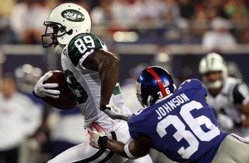 EAST RUTHERFORD, NJ - AUGUST 29:  Jerricho Cotchery #89 of the New York Jets runs the ball against Travonti Johnson #36 of the New York Giants on August 29, 2009 at Giants Stadium in East Rutherford, New Jersey.  (Photo by Jim McIsaac/Getty Images)