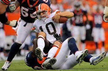 DENVER - SEPTEMBER 20:  Quarterback Brady Quinn #10 of the Cleveland Browns is sacked by defensive end Elvis Dumervil #92 of the Denver Broncos in the fourth quarter during NFL action at Invesco Field at Mile High on September 20, 2009 in Denver, Colorado