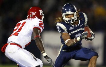 EAST HARTFORD, CT - NOVEMBER 3:  Andre Dixon #2 of the University of Connecticut Huskies gains yardage against Devin McCourty #21 of the Rutgers Scarlet Knights at Rentschler Field November 3, 2007 in East Hartford, Connecticut.  (Photo by Jim Rogash/Gett
