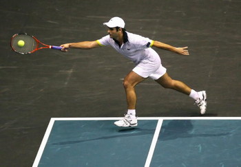 BANGKOK, THAILAND - SEPTEMBER 29:  Fabrice Santoro of France stretches for a forehand in his match against Evgeny Korolev of Russia during day four of the 2009 Thailand Open at Impact Arena on September 29, 2009 in Bangkok, Thailand.  (Photo by Mark Dadsw