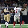 6 Jan 2002: Quarterback Michael Vick #7 of  the Atlanta Falcons sneaks a pass off before being tackled by Leonard Little #91 of the St.Louis Rams at the Dome at America's Center in St. Louis, Missouri.The St. Louis Rams beat the Atlanta Falcons 31-13.  DI