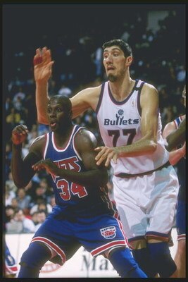 11 Apr 1997: Center Gheorghe Mursean of the Washington Bullets tries to guard forward Xavier McDaniel of the New Jersey Nets at the US Air Arena in Landover, Maryland. The Bullets won the game 109-90.